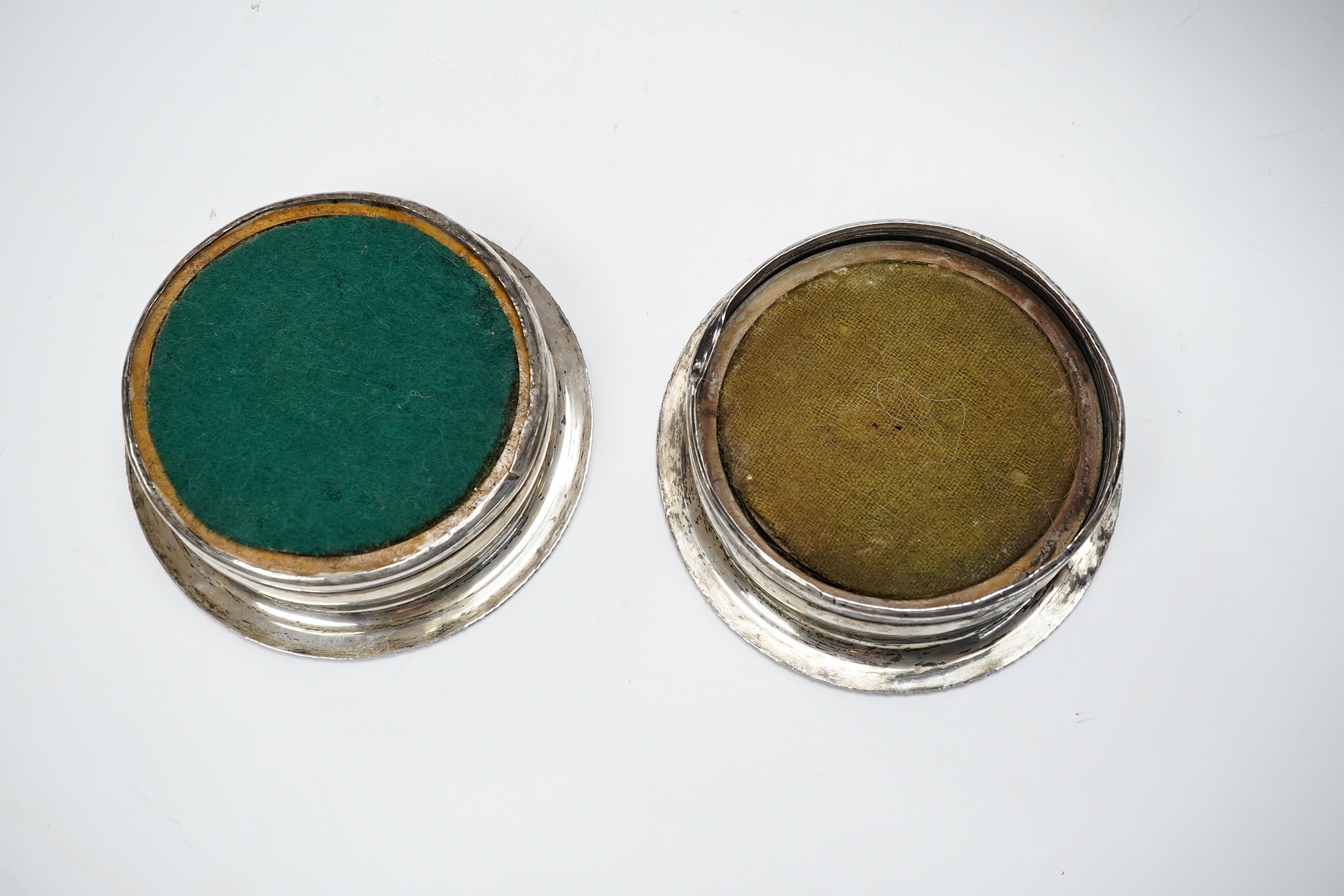 A pair of George III silver wine coasters, by John Roberts & Co, with gadrooned borders and turned wooden bases, Sheffield, 1810, diameter 15.9cm. Condition - poor